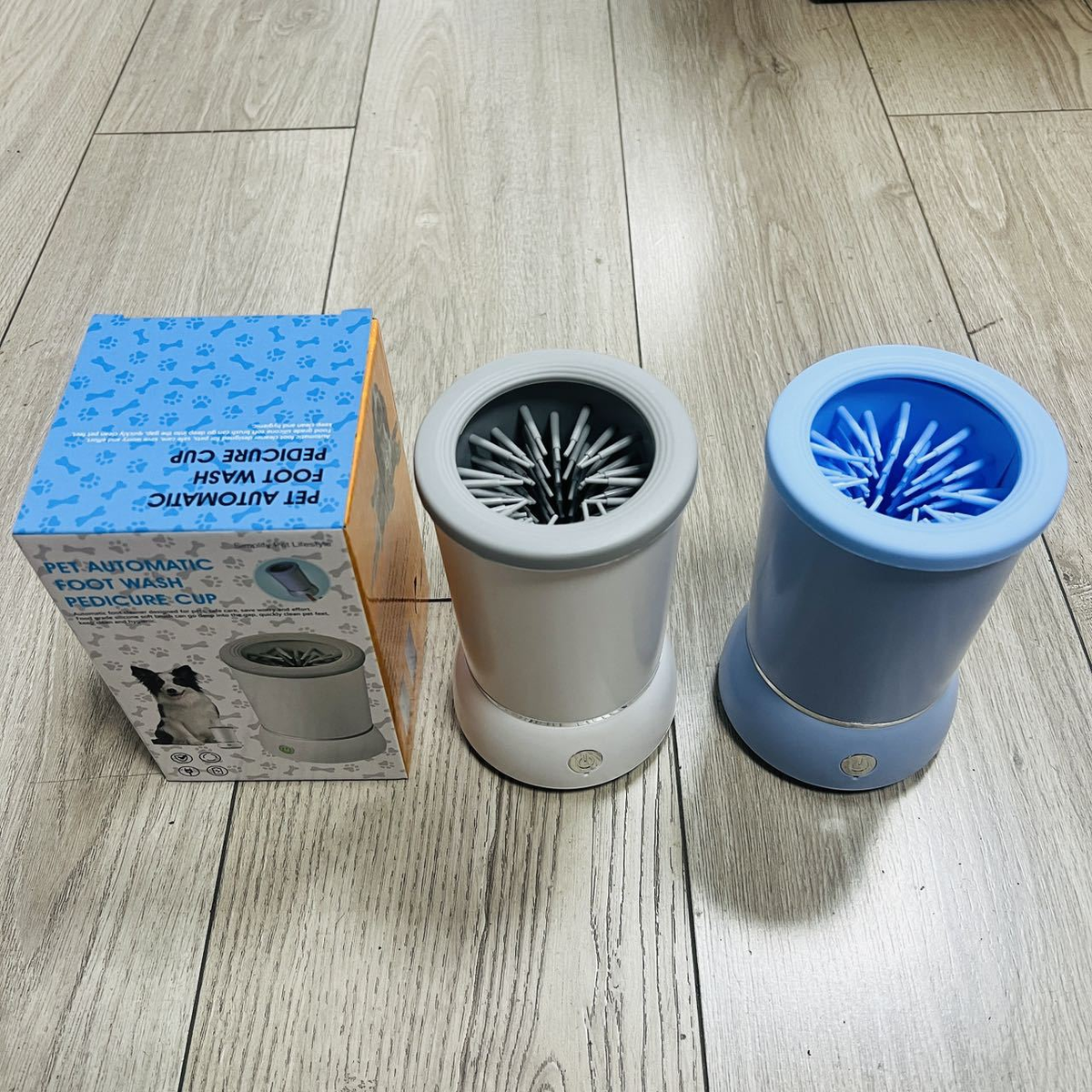 White and blue automatic dog paw cleaner cups with internal cleaning bristles for post-walk paw washing
