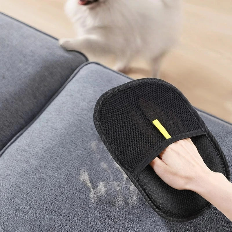 Comfort Zone Pets pet hair remover mesh side used on a gray sofa cushion with a cat nearby