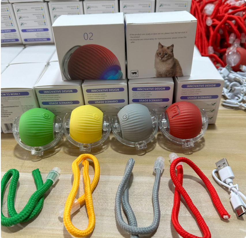 Comfort Zone Pets smart cat ball toys in green, yellow, gray, and red with USB charging cable and retail packaging